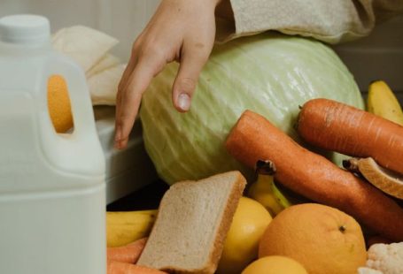 Decluttering - Person Removing Food on the Refrigerator
