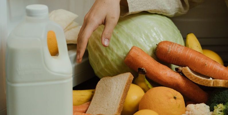 Decluttering - Person Removing Food on the Refrigerator