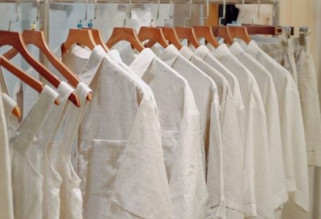 Capsule Wardrobe - Clothes in Neutral Colors Hanging on the Racks in a Clothing Store