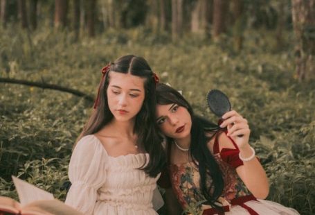 Book Releases - Two women in dresses sitting in the woods