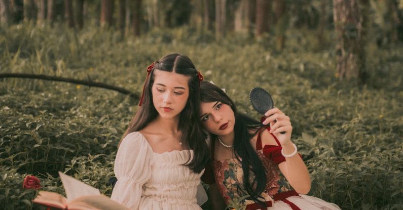 Book Releases - Two women in dresses sitting in the woods